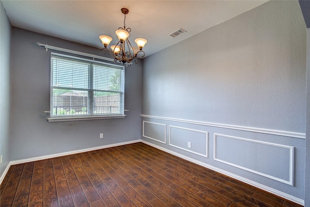 1015 Midnight Pass, Rockwall, TX 75087 - spare room featuring a chandelier and dark wood finished floors