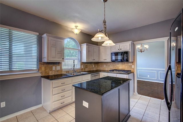 1015 Midnight Pass, Rockwall, TX 75087 - kitchen featuring black appliances, decorative backsplash, light tile patterned flooring, a kitchen island, and pendant lighting