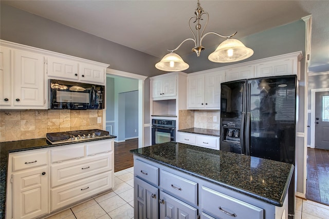 1015 Midnight Pass, Rockwall, TX 75087 - kitchen with black appliances, white cabinets, decorative backsplash, dark stone counters, and light tile patterned floors