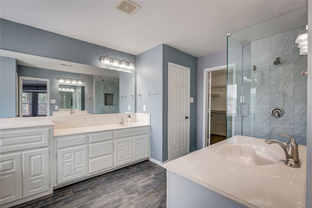 1015 Midnight Pass, Rockwall, TX 75087 - bathroom with a shower stall, vanity, and wood finish floors