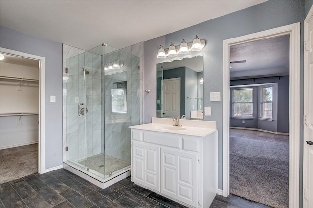 1015 Midnight Pass, Rockwall, TX 75087 - full bathroom with a stall shower, vanity, and a walk in closet