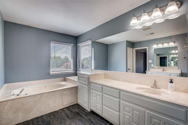 1015 Midnight Pass, Rockwall, TX 75087 - bathroom with vanity, a bath, and wood tiled floors