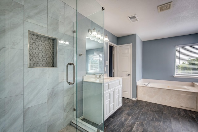 1015 Midnight Pass, Rockwall, TX 75087 - full bath with a garden tub, a shower stall, vanity, and wood finished floors