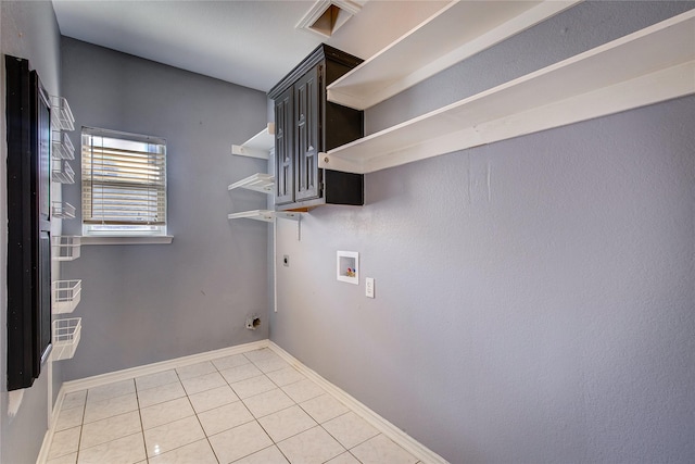 1015 Midnight Pass, Rockwall, TX 75087 - laundry area with electric dryer hookup, cabinet space, washer hookup, and light tile patterned floors