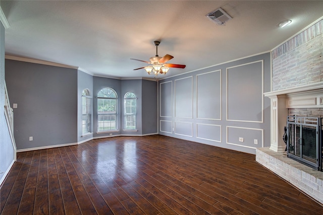 1015 Midnight Pass, Rockwall, TX 75087 - unfurnished living room featuring a decorative wall, a ceiling fan, a fireplace, crown molding, and wood finished floors