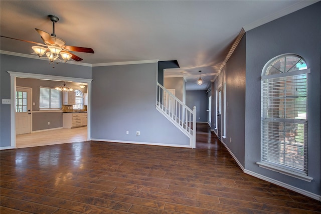 1015 Midnight Pass, Rockwall, TX 75087 - unfurnished living room with a ceiling fan, a chandelier, stairs, crown molding, and wood-type flooring
