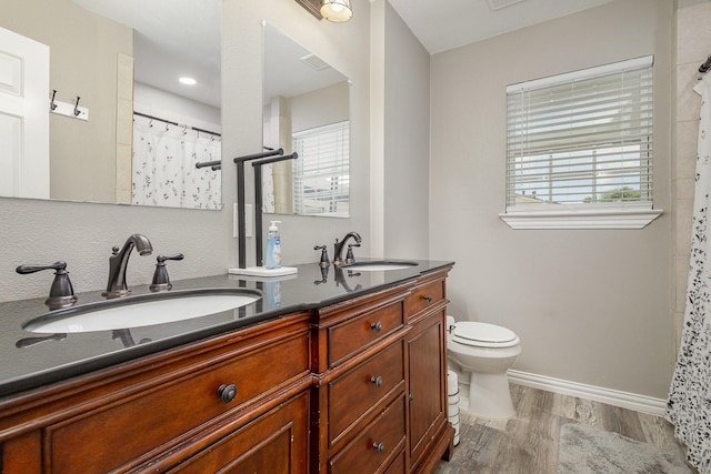 621 New Market Rd, Mesquite, TX 75149 - bathroom featuring wood finished floors, double vanity, plenty of natural light, and curtained shower