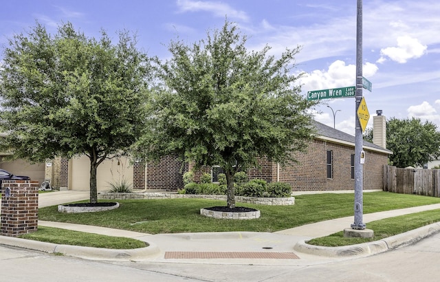 2600 Canyon Wren Ln, Fort Worth, TX 76244 - view of property hidden behind natural elements featuring brick siding, a garage, driveway, and a chimney