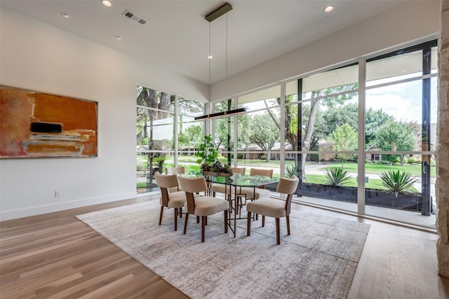 4025 Hockaday Dr, Dallas, TX 75229 - dining area featuring wood finished floors, recessed lighting, and a towering ceiling