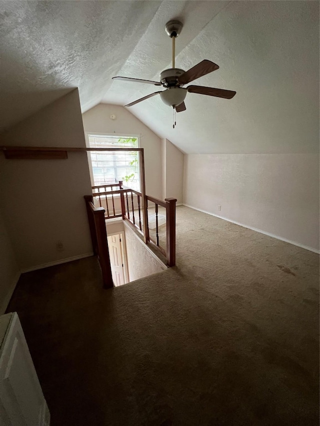 710 W Main St, Denison, TX 75020 - additional living space featuring lofted ceiling, carpet floors, ceiling fan, and a textured ceiling