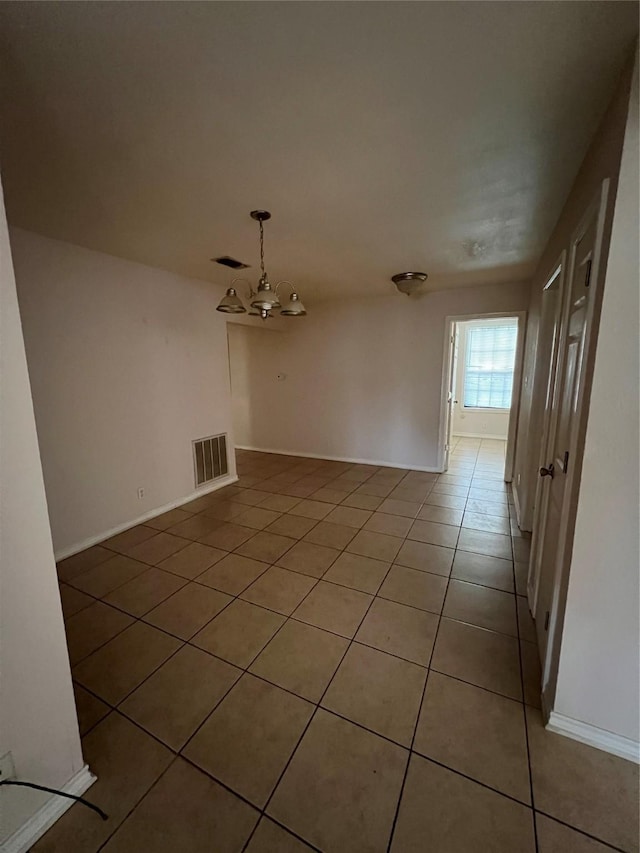 710 W Main St, Denison, TX 75020 - spare room featuring light tile patterned flooring and a chandelier