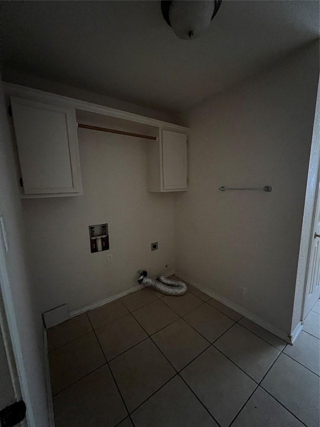 710 W Main St, Denison, TX 75020 - washroom featuring hookup for an electric dryer, cabinet space, hookup for a washing machine, light tile patterned floors, and gas dryer hookup