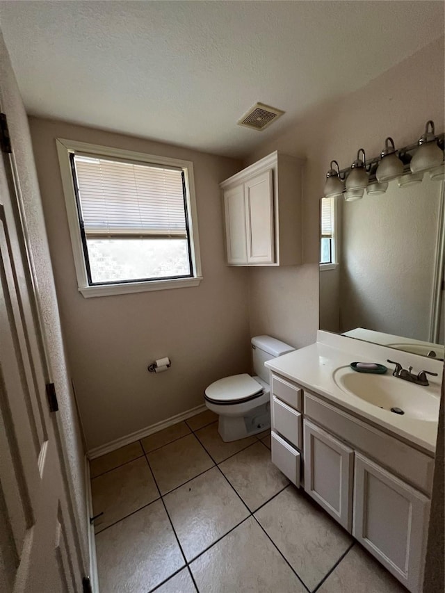 710 W Main St, Denison, TX 75020 - bathroom with vanity, tile patterned floors, and a textured ceiling