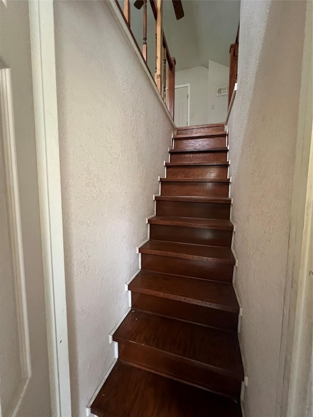 710 W Main St, Denison, TX 75020 - staircase featuring a textured wall and vaulted ceiling