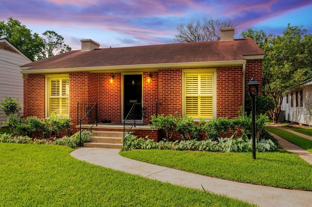 473 Albany Ave, Shreveport, LA 71105 - view of front facade featuring a chimney, brick siding, a front yard, and a shingled roof