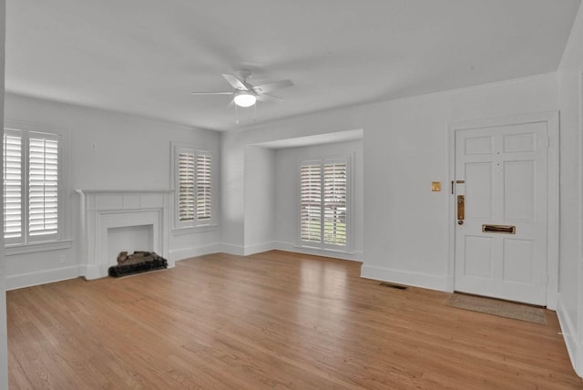 473 Albany Ave, Shreveport, LA 71105 - unfurnished living room with ceiling fan, light wood finished floors, and a fireplace