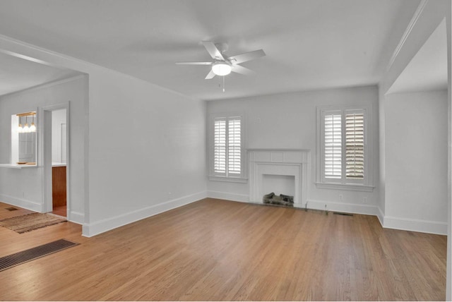 473 Albany Ave, Shreveport, LA 71105 - unfurnished living room with wood finished floors, a ceiling fan, a fireplace, and a chandelier