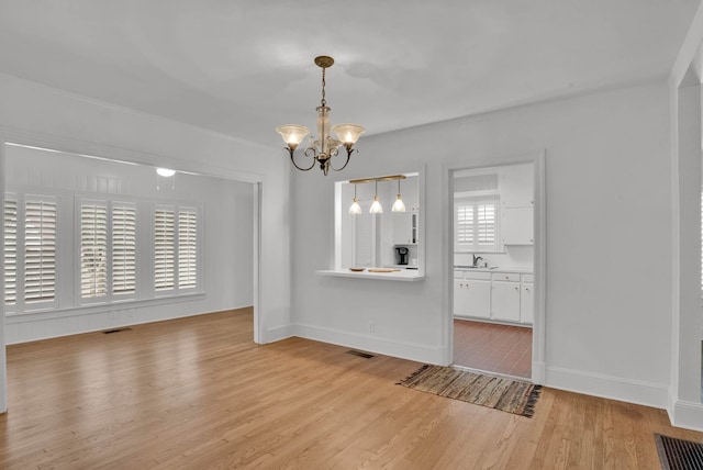 473 Albany Ave, Shreveport, LA 71105 - unfurnished dining area featuring a chandelier and light wood-style flooring