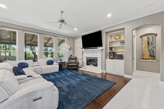 4105 Tree House Ln, Corinth, TX 76208 - living area with marble tiled floors, ornamental molding, arched walkways, a ceiling fan, and recessed lighting