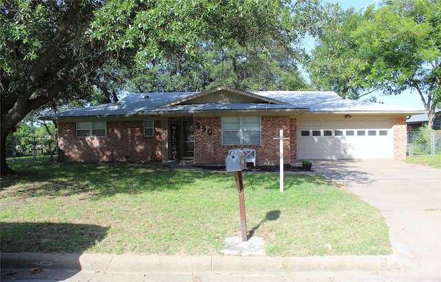 590 N Charlotte Ave, Stephenville, TX 76401 - ranch-style house with an attached garage, concrete driveway, and brick siding