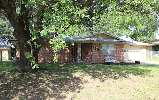 590 N Charlotte Ave, Stephenville, TX 76401 - ranch-style home featuring an attached garage, brick siding, and driveway