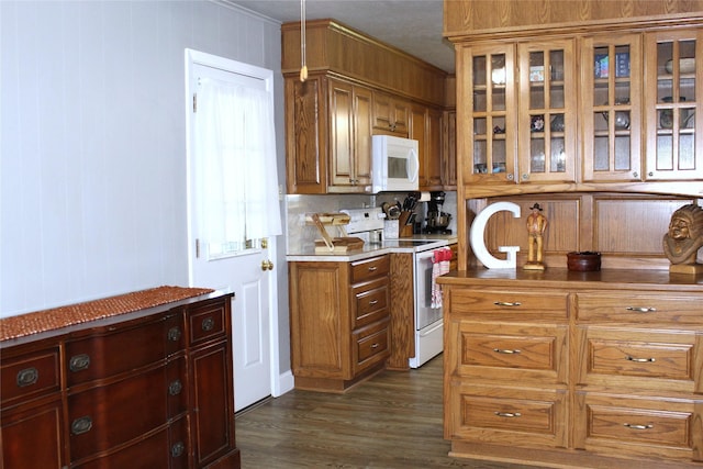 590 N Charlotte Ave, Stephenville, TX 76401 - kitchen featuring white appliances, dark wood-style flooring, glass insert cabinets, brown cabinets, and crown molding