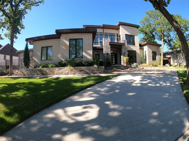 548 Oak Grove Ln, Coppell, TX 75019 - contemporary house featuring stone siding, stucco siding, a balcony, and a front lawn
