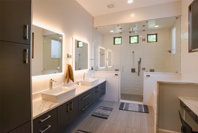 548 Oak Grove Ln, Coppell, TX 75019 - bathroom with a shower stall, double vanity, and recessed lighting