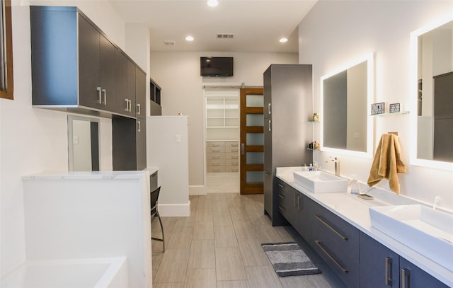 548 Oak Grove Ln, Coppell, TX 75019 - full bathroom with double vanity, recessed lighting, and a tub