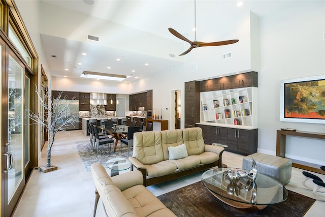 548 Oak Grove Ln, Coppell, TX 75019 - living area with a ceiling fan, recessed lighting, light tile patterned floors, and a towering ceiling