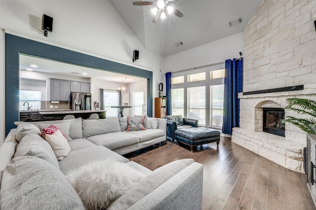 3129 Dawn Oaks Dr, Denton, TX 76208 - living room with ceiling fan, dark wood-type flooring, a fireplace, healthy amount of natural light, and high vaulted ceiling