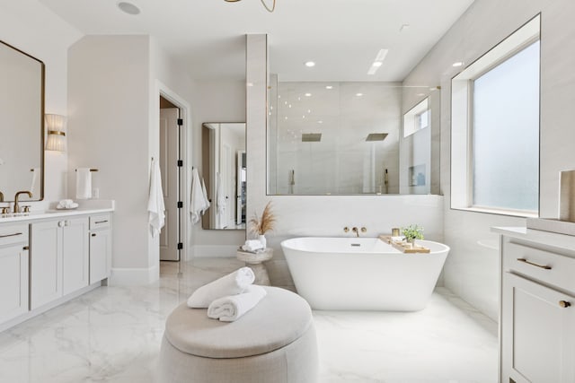 4400 Honeyvine Ln, Prosper, TX 75078 - bathroom featuring marble tiled floors, vanity, a shower stall, a freestanding bath, and recessed lighting
