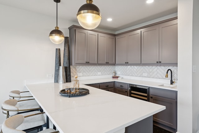 4400 Honeyvine Ln, Prosper, TX 75078 - kitchen featuring a kitchen breakfast bar, a peninsula, backsplash, gray cabinetry, and recessed lighting