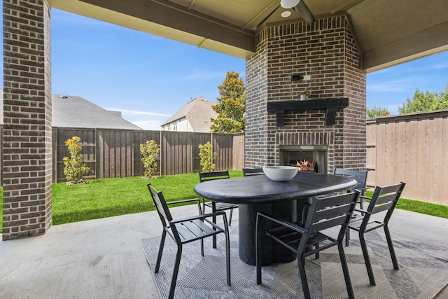 4400 Honeyvine Ln, Prosper, TX 75078 - fenced backyard with an outdoor brick fireplace, outdoor dining space, and a patio