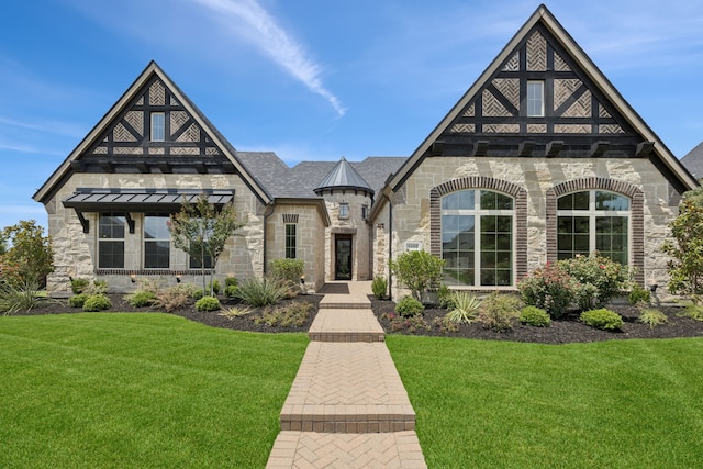 4400 Honeyvine Ln, Prosper, TX 75078 - view of front of home with stone siding, a standing seam roof, a front yard, and a metal roof