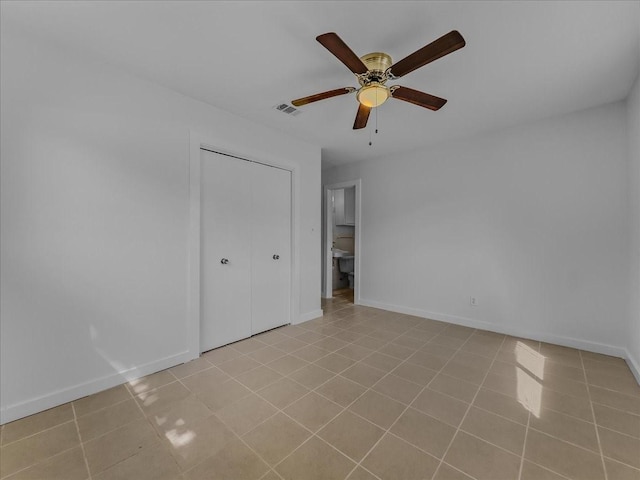 202 E Rentz St, Weatherford, TX 76086 - unfurnished bedroom featuring light tile patterned floors, a closet, and a ceiling fan