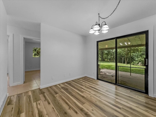 202 E Rentz St, Weatherford, TX 76086 - unfurnished room featuring a chandelier and wood finished floors