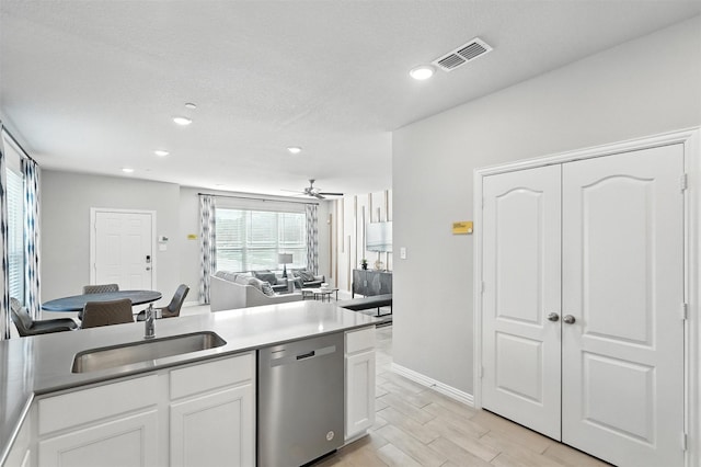 3001 Percheron Dr, Mesquite, TX 75150 - kitchen featuring dishwasher, white cabinetry, open floor plan, recessed lighting, and wood tiled floors