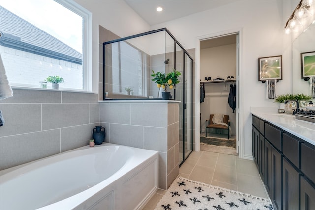 5511 Grand Ave, Sachse, TX 75048 - full bath featuring a garden tub, a stall shower, vanity, tile patterned floors, and a walk in closet