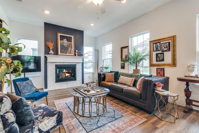 5511 Grand Ave, Sachse, TX 75048 - living area featuring a ceiling fan, a glass covered fireplace, wood finished floors, and recessed lighting