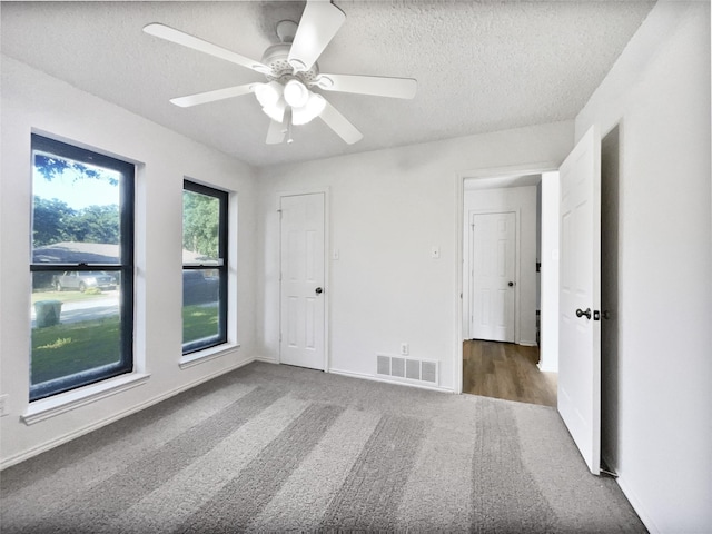 5417 Grissom Dr, Arlington, TX 76016 - unfurnished bedroom with carpet flooring, a textured ceiling, and a ceiling fan