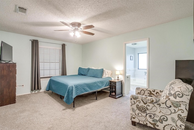 321 E Hampton Rd, Crowley, TX 76036 - carpeted bedroom featuring ensuite bathroom, a textured ceiling, and a ceiling fan