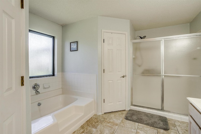 321 E Hampton Rd, Crowley, TX 76036 - bathroom featuring a garden tub, a shower stall, vanity, and a textured ceiling