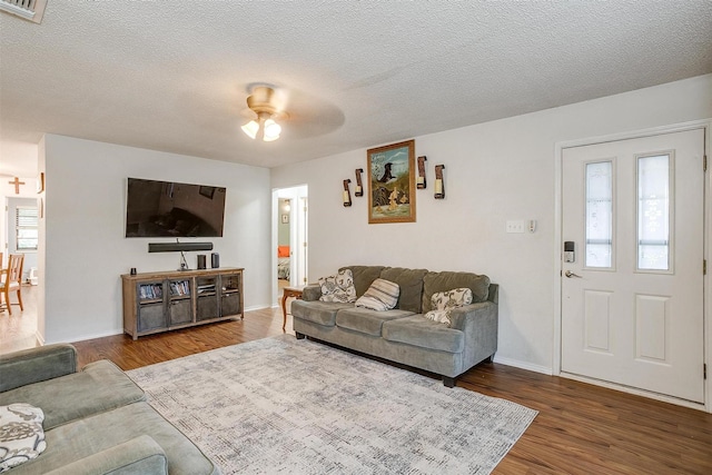 321 E Hampton Rd, Crowley, TX 76036 - living room with wood finished floors, a ceiling fan, and a textured ceiling