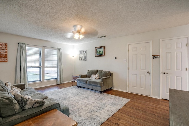 321 E Hampton Rd, Crowley, TX 76036 - living area with wood finished floors, ceiling fan, and a textured ceiling