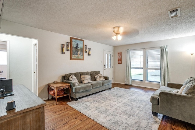 321 E Hampton Rd, Crowley, TX 76036 - living area featuring wood finished floors and a textured ceiling