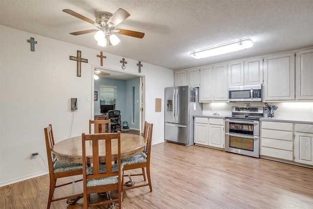 321 E Hampton Rd, Crowley, TX 76036 - kitchen with stainless steel appliances, light wood-style flooring, ceiling fan, a textured ceiling, and light countertops