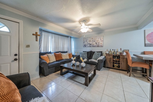 714 Macgregor Dr, Grand Prairie, TX 75050 - living room featuring crown molding, light tile patterned floors, a ceiling fan, a textured ceiling, and a dry bar