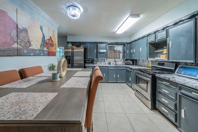 714 Macgregor Dr, Grand Prairie, TX 75050 - kitchen with appliances with stainless steel finishes, open shelves, a textured ceiling, light tile patterned flooring, and light countertops