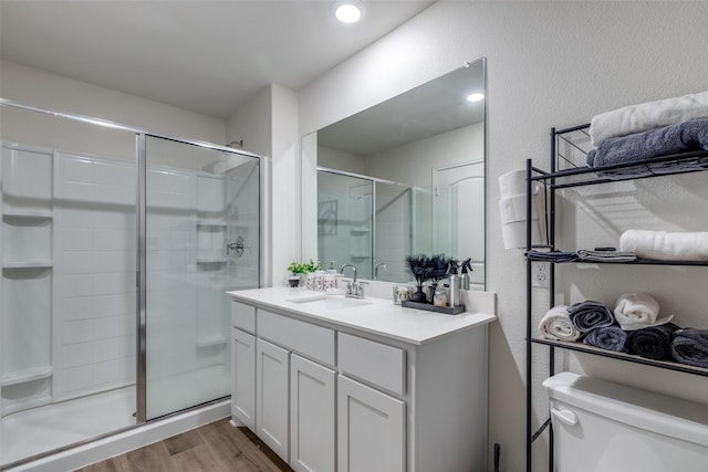 206 Marsh Ln, Princeton, TX 75407 - bathroom featuring wood finished floors, vanity, a stall shower, and a textured wall
